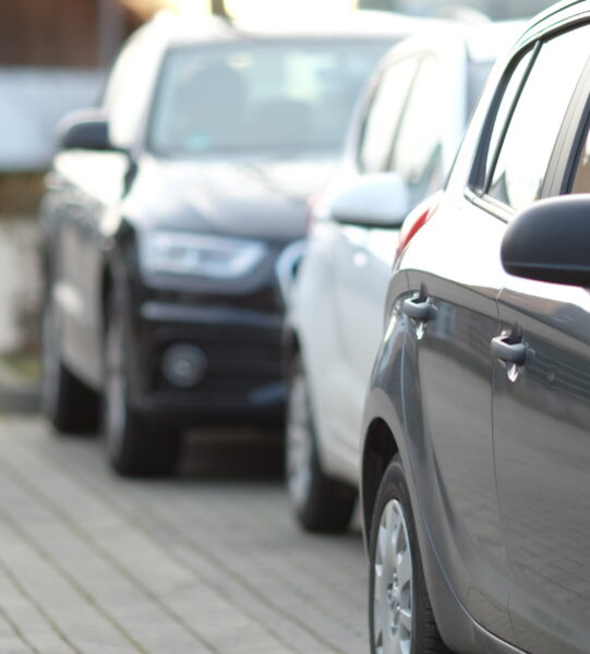 closeup-shot-black-car-parking-lot-with-blurred-background closeup-shot-black-car-parking-lot-with-blurred-background